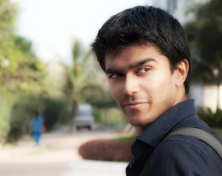 a close up of a person with a backpack, a picture, inspired by Bikash Bhattacharjee, flickr, hurufiyya, a handsome man，black short hair, around 20 yo, blank stare”, unibrow