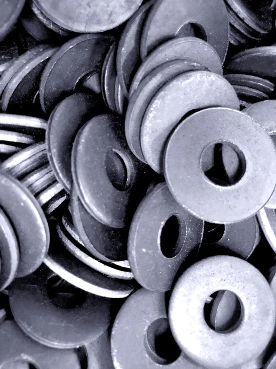 a pile of metal washers sitting on top of each other, a photo, bauhaus, ((oversaturated)), grayish, center punched, glazed