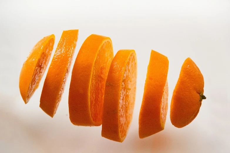 a close up of sliced oranges on a white surface, a picture, by Jakob Gauermann, carrots, long shot wide shot full shot, turnaround, rung