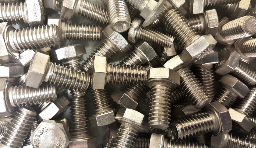 a pile of nuts and bolts sitting on top of a table