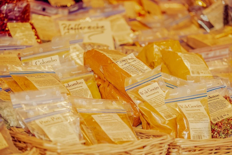 a basket filled with lots of different types of cheese, a picture, by Thomas Häfner, pexels, figuration libre, sliced bread in slots, with labels. high quality, shades of gold display naturally, colombian