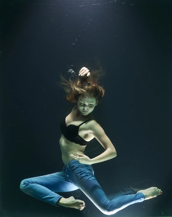 a woman in a black top is in the water, a portrait, by Elizabeth Polunin, conceptual art, volumetric underwater lighting, very accurate photo, powerful woman sitting in space, full shot photo