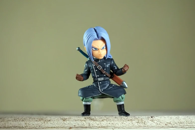 a close up of a figurine of a person with a sword, a character portrait, inspired by INO, little angry girl with blue hair, very very low quality picture, combat stance, official product photo