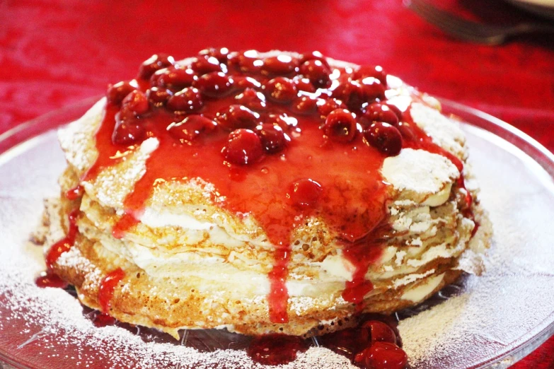 a close up of a cake on a plate on a table, by Dietmar Damerau, flickr, rasquache, living food adorable pancake, cherry explosion, chile, russian