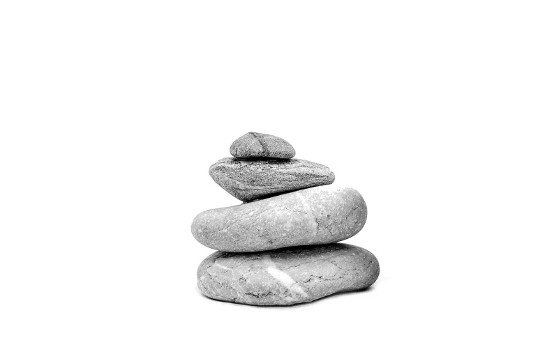 a stack of rocks sitting on top of each other, a black and white photo, minimalism, detailed product photo, on a white background, peace, bread
