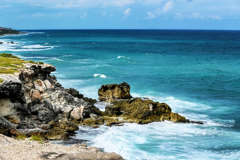a man standing on top of a cliff next to the ocean, carribean turquoise water, rough waves, usa-sep 20, edited