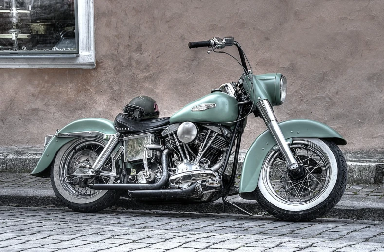 a green motorcycle parked on the side of a street, by Arnie Swekel, trending on pixabay, photorealism, harley davidson, cold colors. insanely detailed, late - 4 0 s aged, speeder