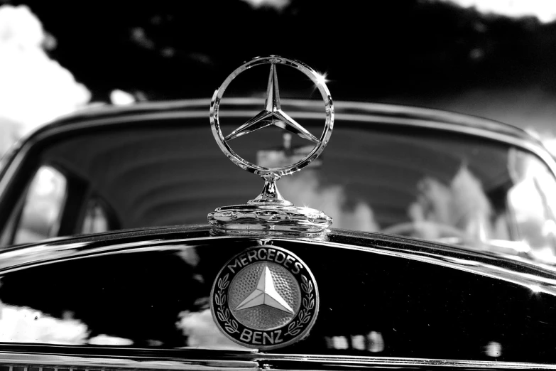 a black and white photo of a mercedes hood ornament, a photo, arabesque, camaraderie, watch photo, emblem of wisdom, heroic!!!