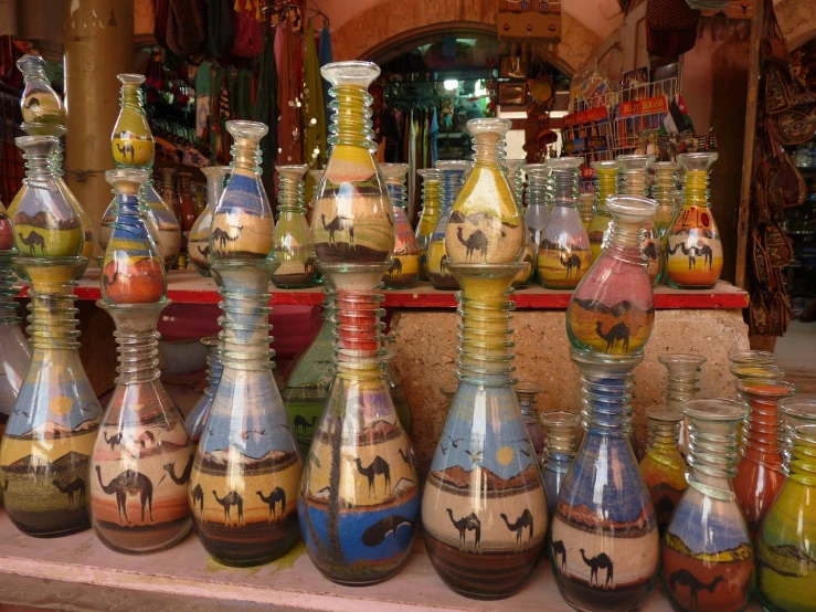 a group of vases sitting on top of a table, egyptian art, by Ken Elias, flickr, futuristic marrakech morocco, camels, glass paint, quaint