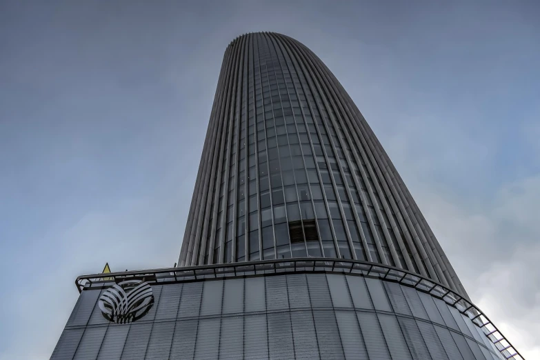 a very tall building with a clock on it's side, a stock photo, inspired by Zaha Hadid, wide angle shot 4 k hdr, rounded roof, grey, phoenix