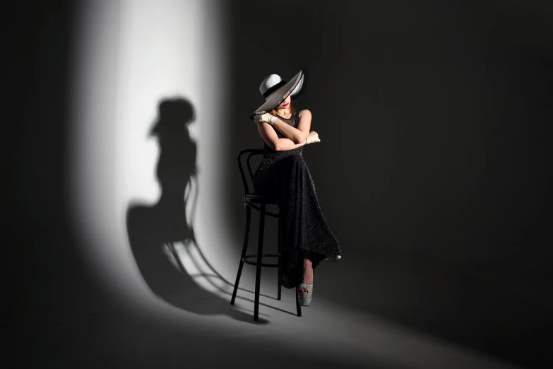 a woman sitting in a chair with a hat on her head, inspired by Lillian Bassman, trending on cg society, backlight studio lighting, long shadow, award winning studio photo, very accurate photo