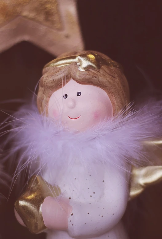 a close up of a figurine of an angel, a macro photograph, sweet smile, golden feathers, holiday season, fluffy