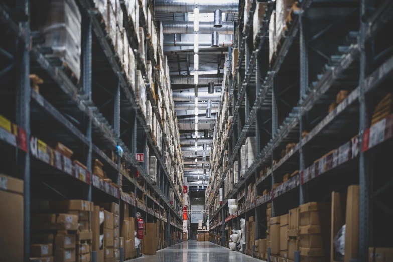 a large warehouse filled with lots of boxes, a picture, pexels, shelves filled with tomes, view from the ground, high quality product image”, artist unknown