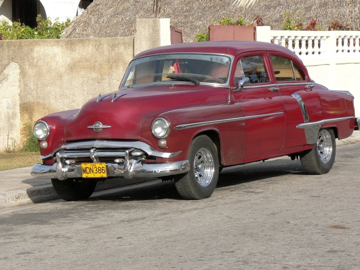 a red classic car parked on the side of the road, by Joseph Henderson, flickr, 30-year-old woman from cuba, tuning, red cloud, full view of a car