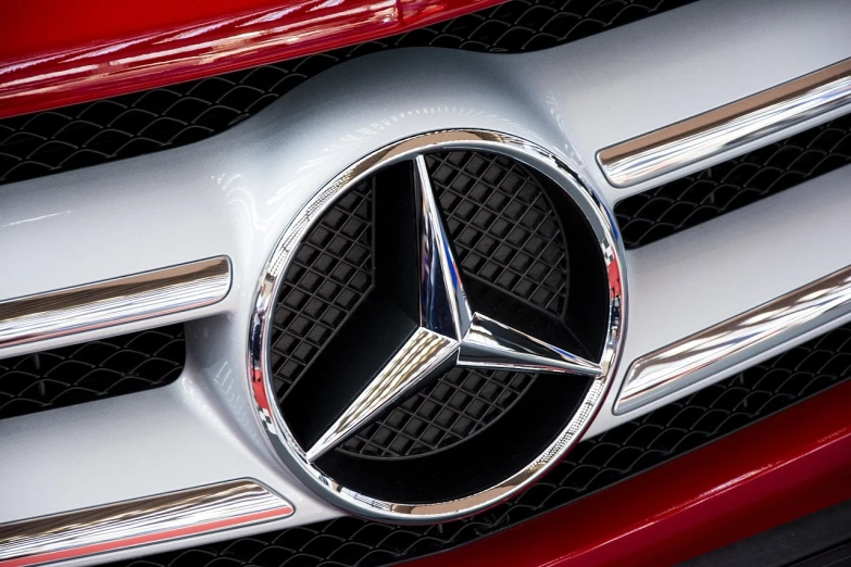 a close up of a mercedes logo on a car, by Hans Schwarz, pexels, photorealism, full colour, plain background, truck, zoomed in