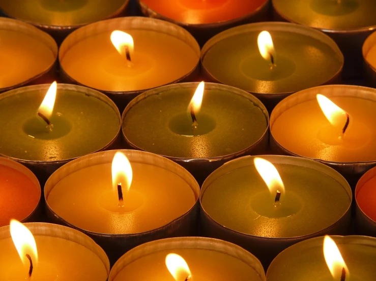 a group of lit candles sitting next to each other, a picture, by Thomas Häfner, istockphoto, full frame shot, multicolored glints, deep detailed