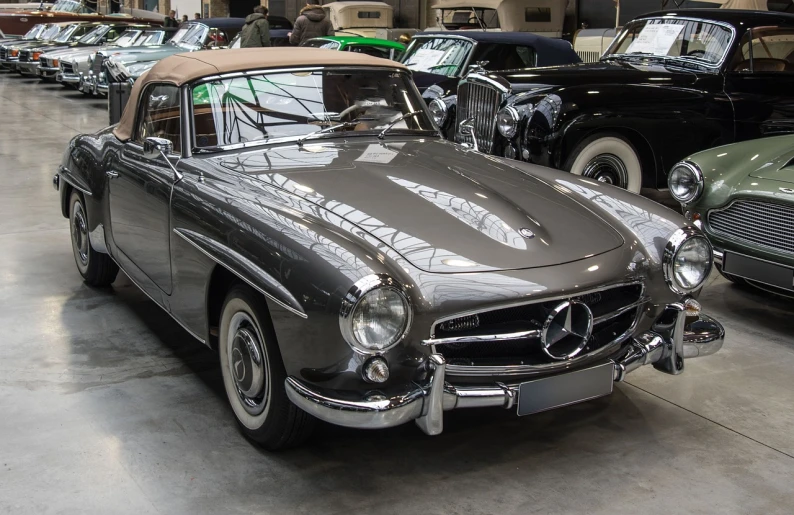 a group of classic cars parked in a garage, a pastel, by Juergen von Huendeberg, shutterstock, mercedez benz, replica model, grey metal body, front top side view