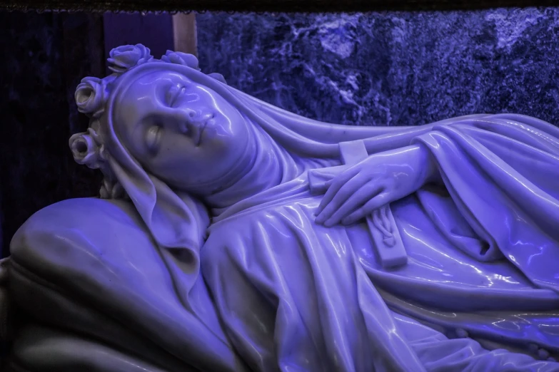 a close up of a statue of a woman, a marble sculpture, inspired by Mary Cameron, featured on zbrush central, the catholic pope in his bed, ultraviolet colors, blue toned, inside the tomb of jesus