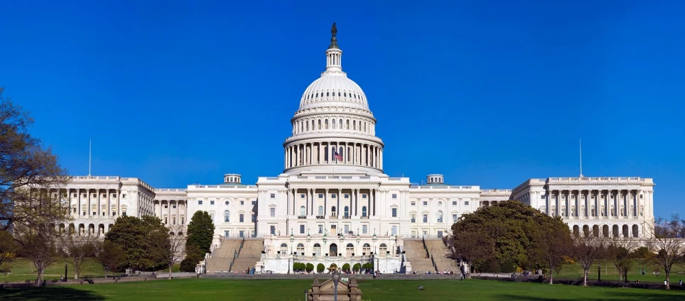 a large white building sitting on top of a lush green field, a picture, capitol building, listing image, a wooden, politicians