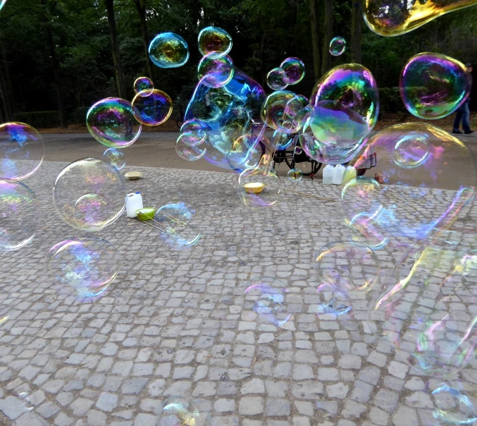 a bunch of soap bubbles floating in the air, by Anna Haifisch, flickr, street art, berlin park, cobblestones, concert, irredecent