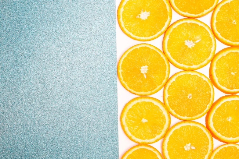 a group of orange slices sitting on top of each other, a stock photo, postminimalism, yellow and cyan color palette, sparkling in the sunlight, still life photo of a backdrop, 🦩🪐🐞👩🏻🦳