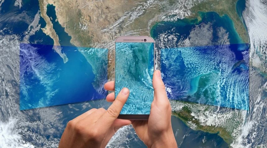a close up of a person holding a cell phone, a hologram, shutterstock, panfuturism, continents, water art photoshop, high res photo, three fourths view