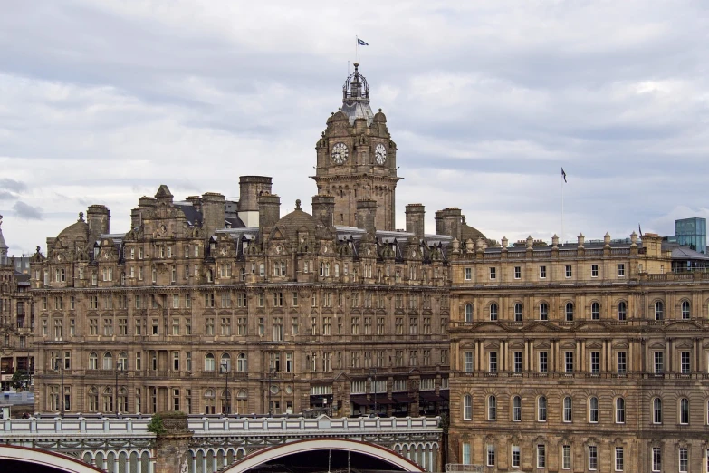 a large building with a clock tower on top of it, by John Murdoch, flickr, all buildings on bridge, round-cropped, inside a grand, royal