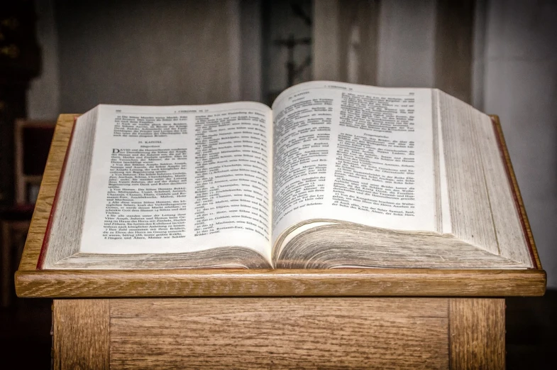an open book sitting on top of a wooden table, by Jason Felix, shutterstock, unilalianism, sacrament, post processed denoised, banner, indoor shot