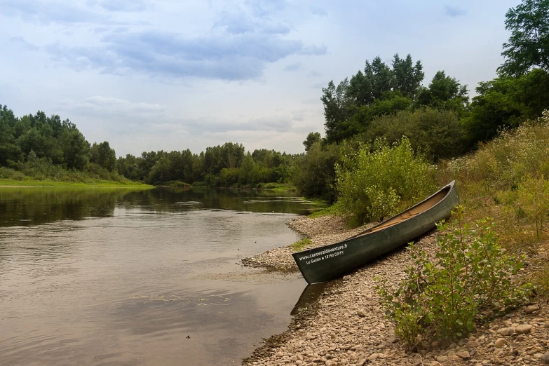 a canoe sitting on the shore of a river, a picture, by Maksimilijan Vanka, shutterstock, wide long view, museum quality photo, river confluence, highly detailed picture