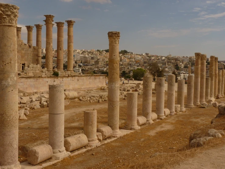 a group of columns sitting in the middle of a dirt field, pexels, neoclassicism, jerusalem, from wikipedia, « attractive, demolition