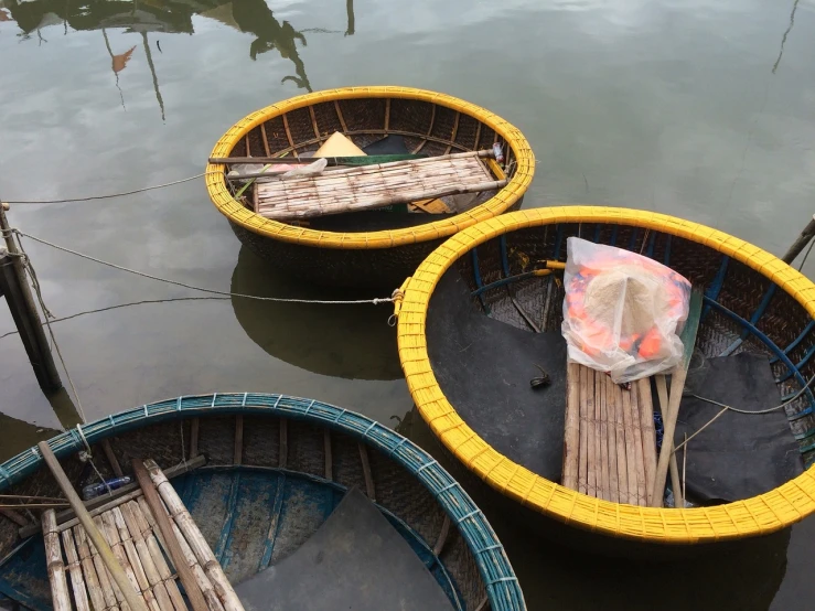 a couple of baskets sitting on top of a body of water, a picture, by Jan Verkolje, dang my linh, repairing the other one, random circular platforms, closeup photo