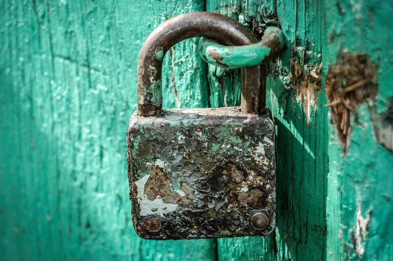 a close up of a lock on a wooden door, a macro photograph, by Adam Szentpétery, pixabay, sickly green colors, battered, instagram post, emerald
