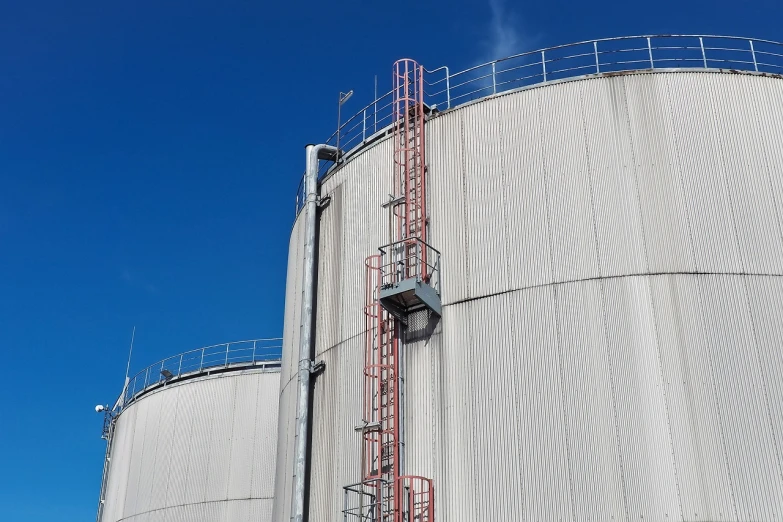 a couple of large metal tanks sitting next to each other, ladders, view from ground, consectetur adipiscing elit, listing image