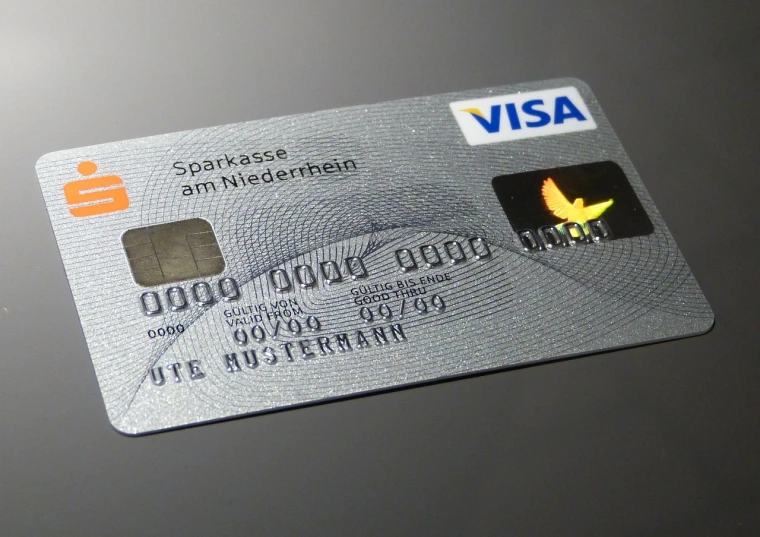 a close up of a visa card on a table, a stipple, by Werner Gutzeit, pixabay, figuration libre, hyper realistic detailed, intense smoldering, on a gray background, in style of ultra realistic