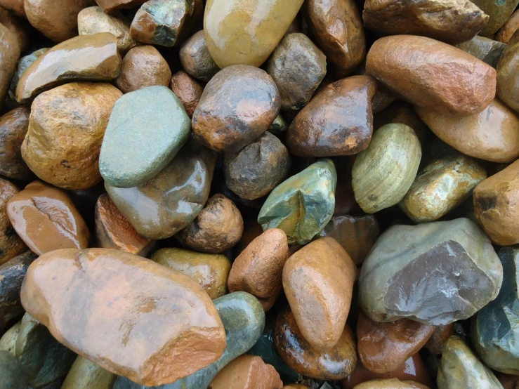 a pile of rocks sitting next to each other, a picture, by Tom Carapic, metallic polished surfaces, wet rocks, gravels around, varied colors