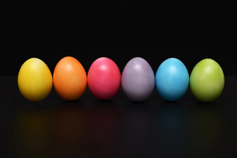 a row of colored easter eggs against a black background, a pastel, by Jan Rustem, pixabay, aaron fallon, group photo, 🦩🪐🐞👩🏻🦳, seven