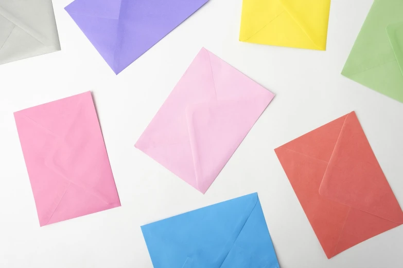 colorful envelopes laid out on a white surface, a picture, by Elias Ravanetti, pexels, letterism, the background is white, kids, beautiful color composition, background image
