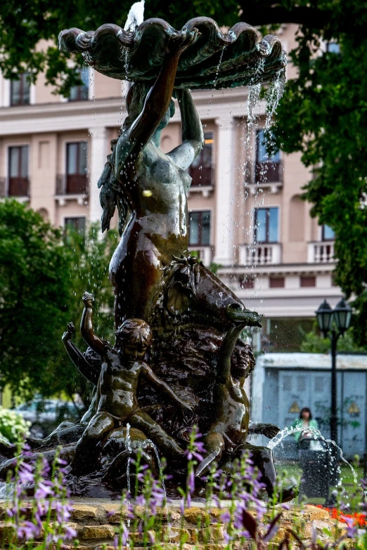 a statue of a woman holding an umbrella, a statue, by Cherryl Fountain, pixabay, 3 nymphs circling a fountain, khreschatyk, low shutter speed, centaur