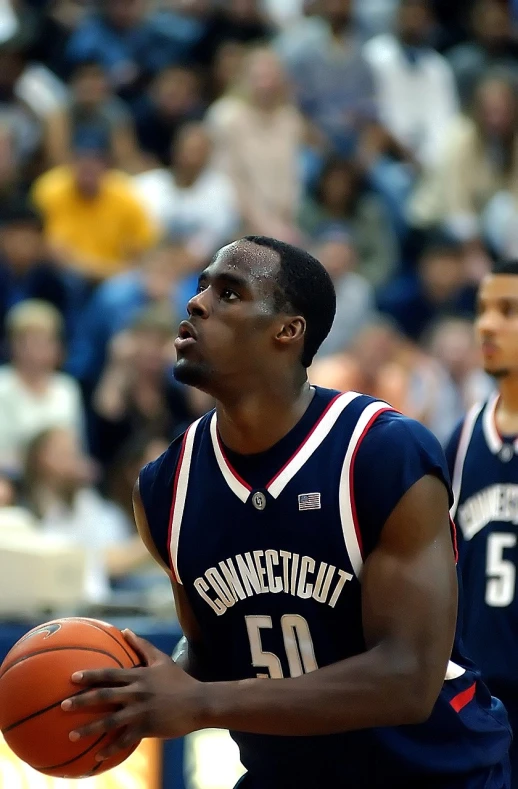 a man holding a basketball in front of a crowd, a picture, by Dean Ellis, flickr, looking to his side, godwin akpan, christian saint, lattice