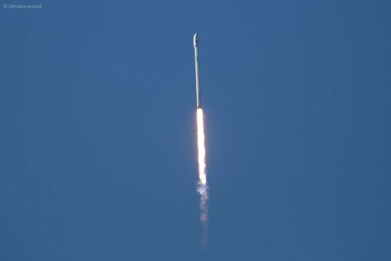 a rocket that is flying through the air, a picture, by Jesse Richards, clear sky above, spears, back towards camera, wikimedia