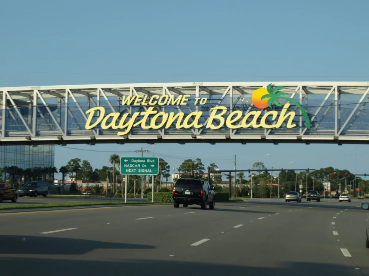 a sign that says welcome to daytona beach, a stock photo, by David Burton-Richardson, ¯_(ツ)_/¯, beans, album photo, 5 5 mm photo