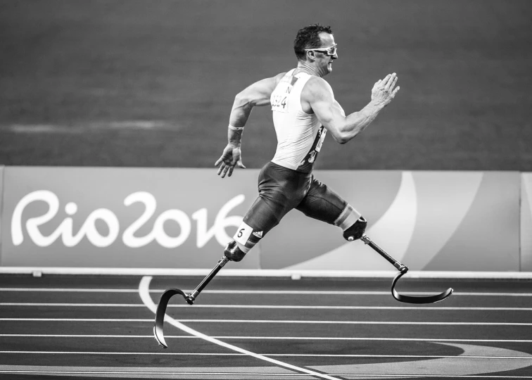 a man with a prosthetic leg running on a track, a black and white photo, by Scott M. Fischer, olympics, 🌻🎹🎼, epic action shot, christophe szpajdel