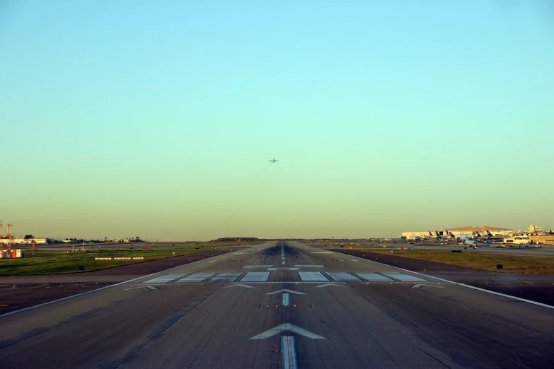 an airplane taking off from an airport runway, a picture, flickr, tx, deserted, long view, angel