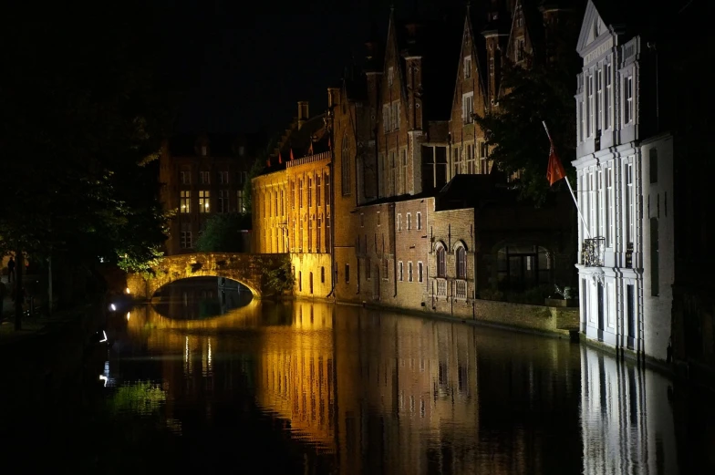 a river running through a city next to tall buildings, a photo, by Jan Tengnagel, renaissance, victorian harbour night, moat, wikipedia, inspiring gothic architecture