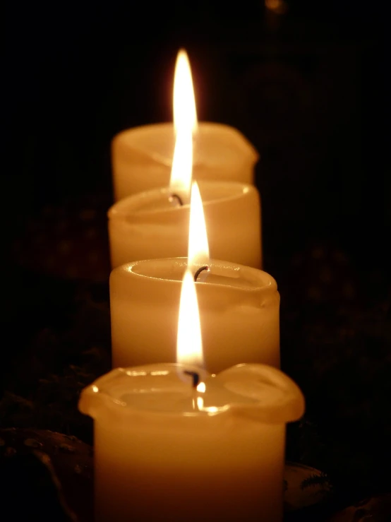 a row of lit candles sitting on top of a table, a picture, flickr, digital image, albino, trio, (1 as december