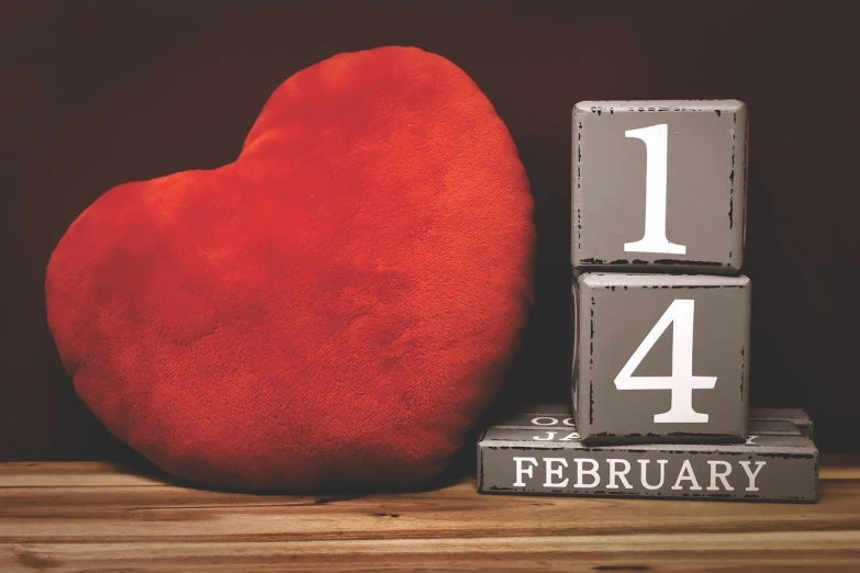 a red heart sitting on top of a wooden table, by Jeanna bauck, happening, year 2447, 1 as february), figure, bl