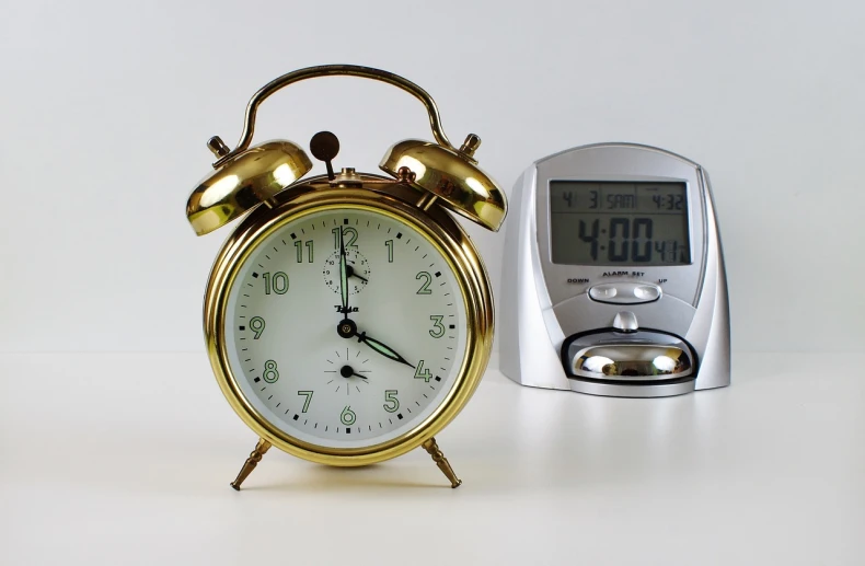 a gold alarm clock next to a silver toaster, a photo, pixabay, watch photo, biological, big clock, set photo