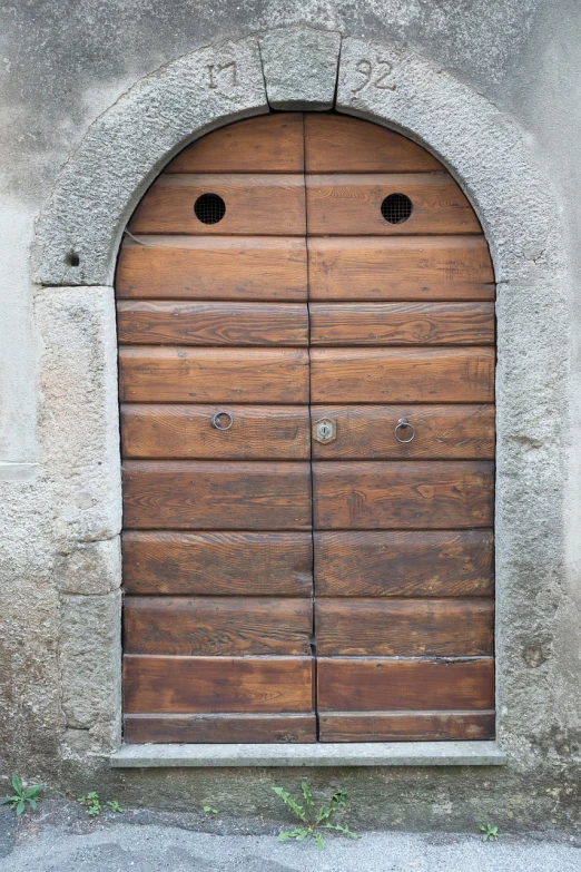 a close up of a wooden door on a building, inspired by Romano Vio, pixabay, with round face, worried, naboo, delightful surroundings