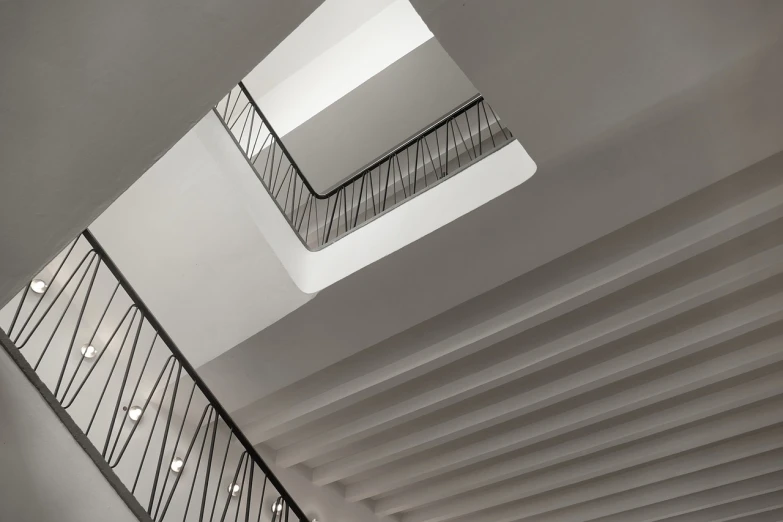 a staircase in a building with a skylight above it, by Mathias Kollros, bauhaus, subtle detailing, benjamin vnuk, architectural finishes, award - winning details