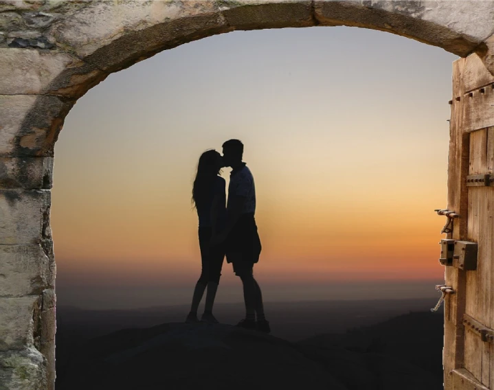 a couple of people that are standing in front of a door, a picture, by John Murdoch, pixabay contest winner, romanticism, sunset view, looking through a portal, kissing together cutely, cliffside